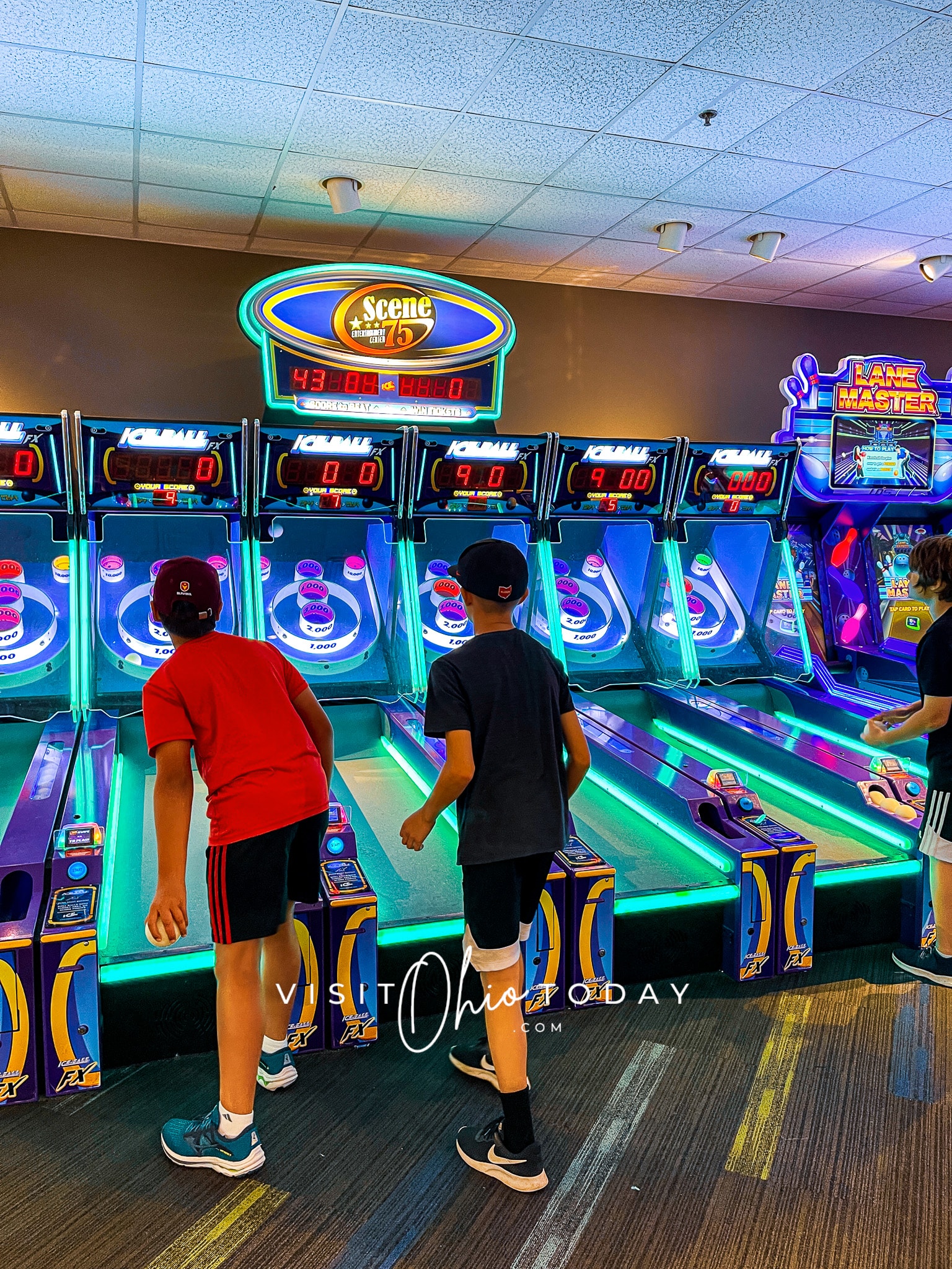 vertical photo of two boys playing on the arcade machines at Scene 75 Columbus Photo credit: Cindy Gordon of VisitOhioToday.com