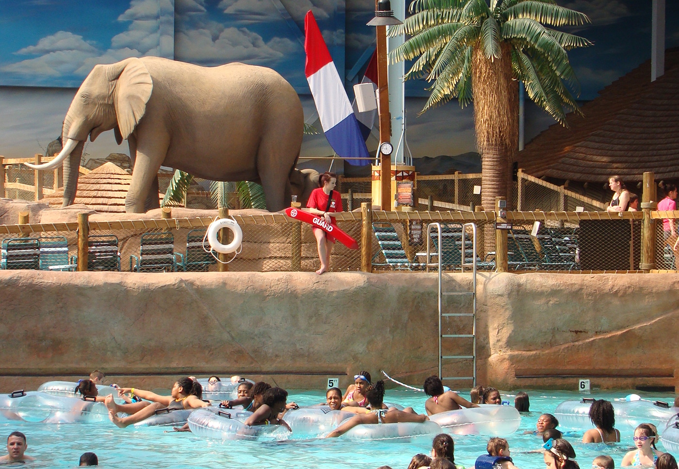 horizontal photo of the kalahari resort indoor water park showing a life size elephant model and a pool with people swimming