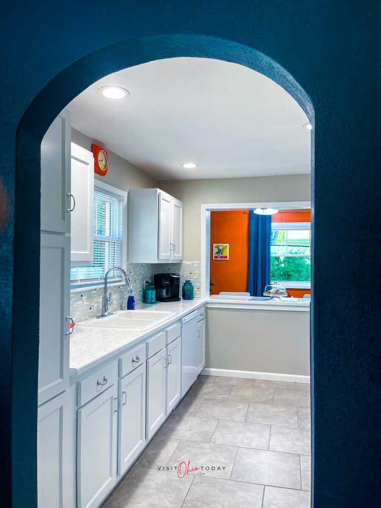 peak into a white kitchen with counter counters, white sink, white floor Photo credit: Cindy Gordon of VisitOhioToday.com