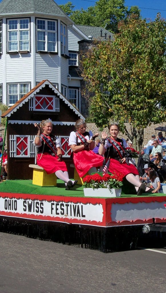 vertical photo of a float with some people dressed in swiss costumes (fall festivals in ohio)