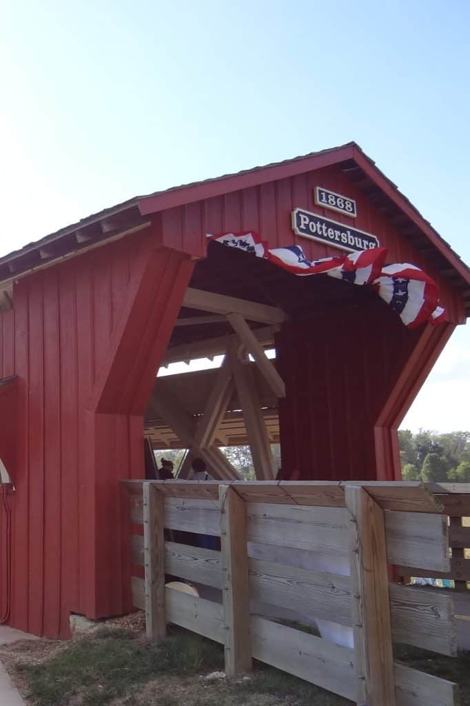 vertical photo showing the front of the red pottersburg covered bridge
