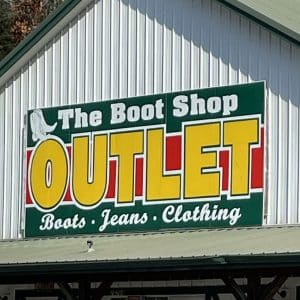 square photo showing the name hoarding outside the boot shop outlet in rockbridge, hocking hills
