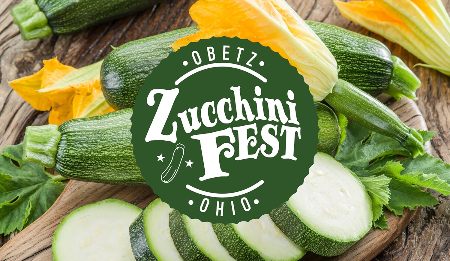 horizontal image of the obetz zucchini fest logo with a selection of whole and sliced zucchinis behind it