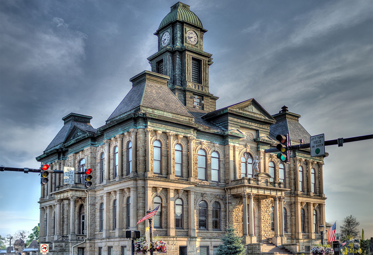 horizontal photo of the Holmes County Courthouse in Millersburg Ohio with an overcast sky. Image Wikimedia Commons https://commons.wikimedia.org/wiki/File:Holmes_County_Court_House_-_July_2016.jpg