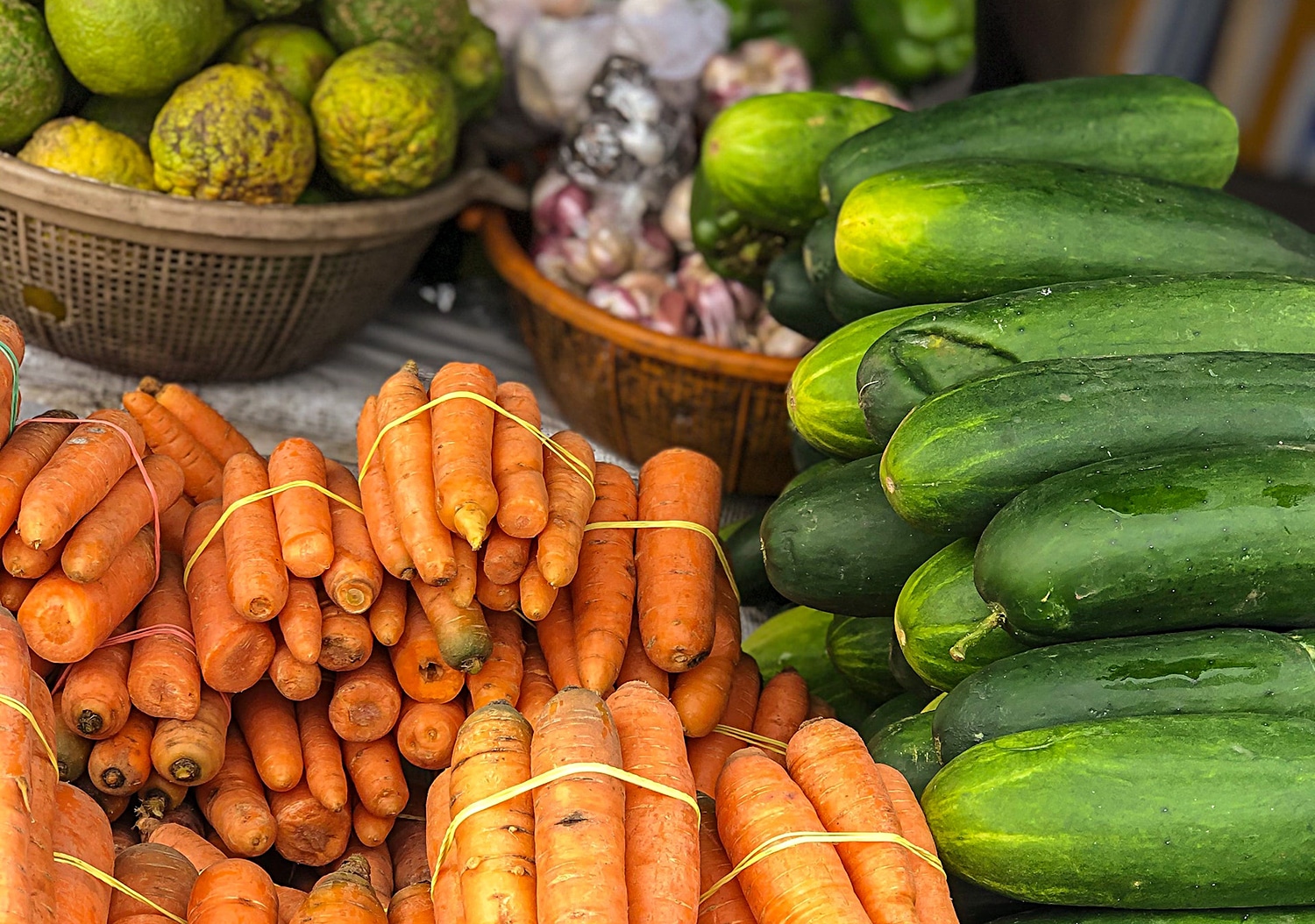 horizontal photo of fresh vegetables for a farmers market item with carrots and cucumbers in the foreground and other fruit and vegetables in the background. Image Pexels https://www.pexels.com/photo/assorted-fresh-vegetables-in-street-market-4258186/