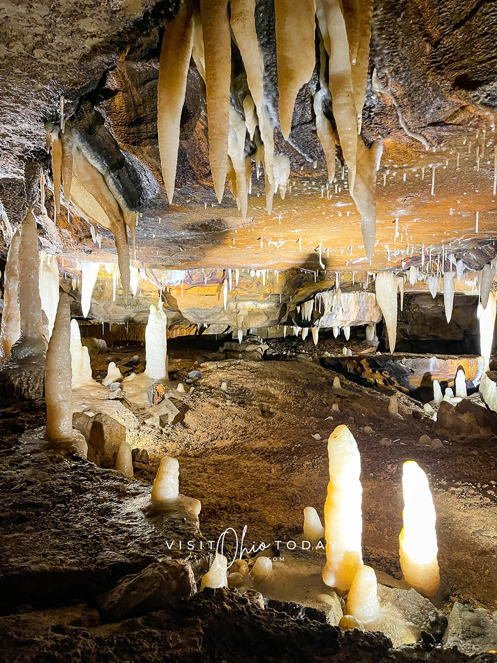 vertical photo of the ohio caverns with stalactites and stalagmites and a pathway through them Photo credit: Cindy Gordon of VisitOhioToday.com