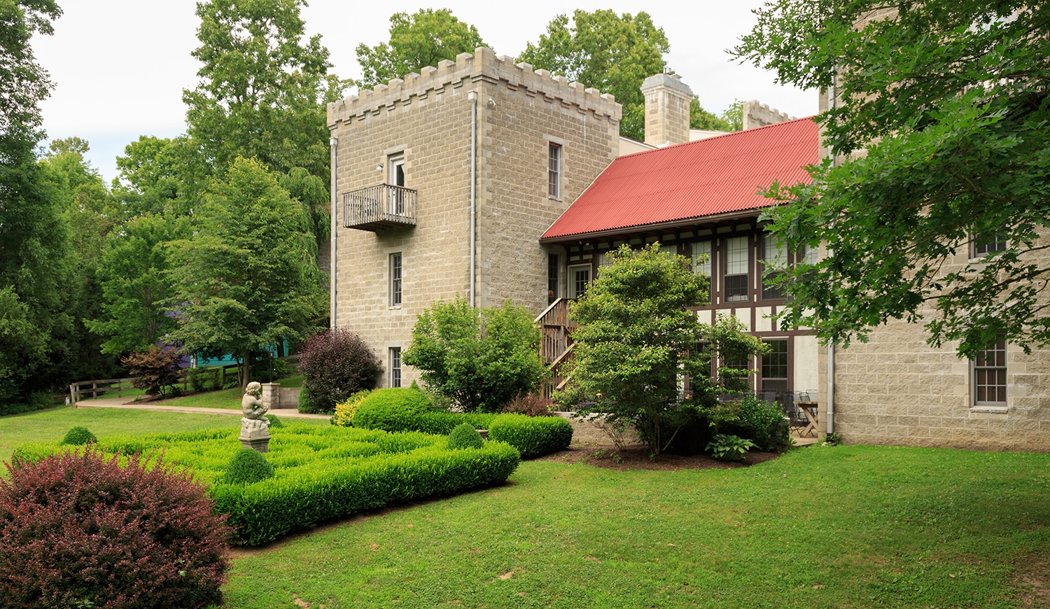horizontal photo of ravenwood castle with a very green lawn in the foreground. Image courtesy of Ravenwood Castle for Castles in Ohio