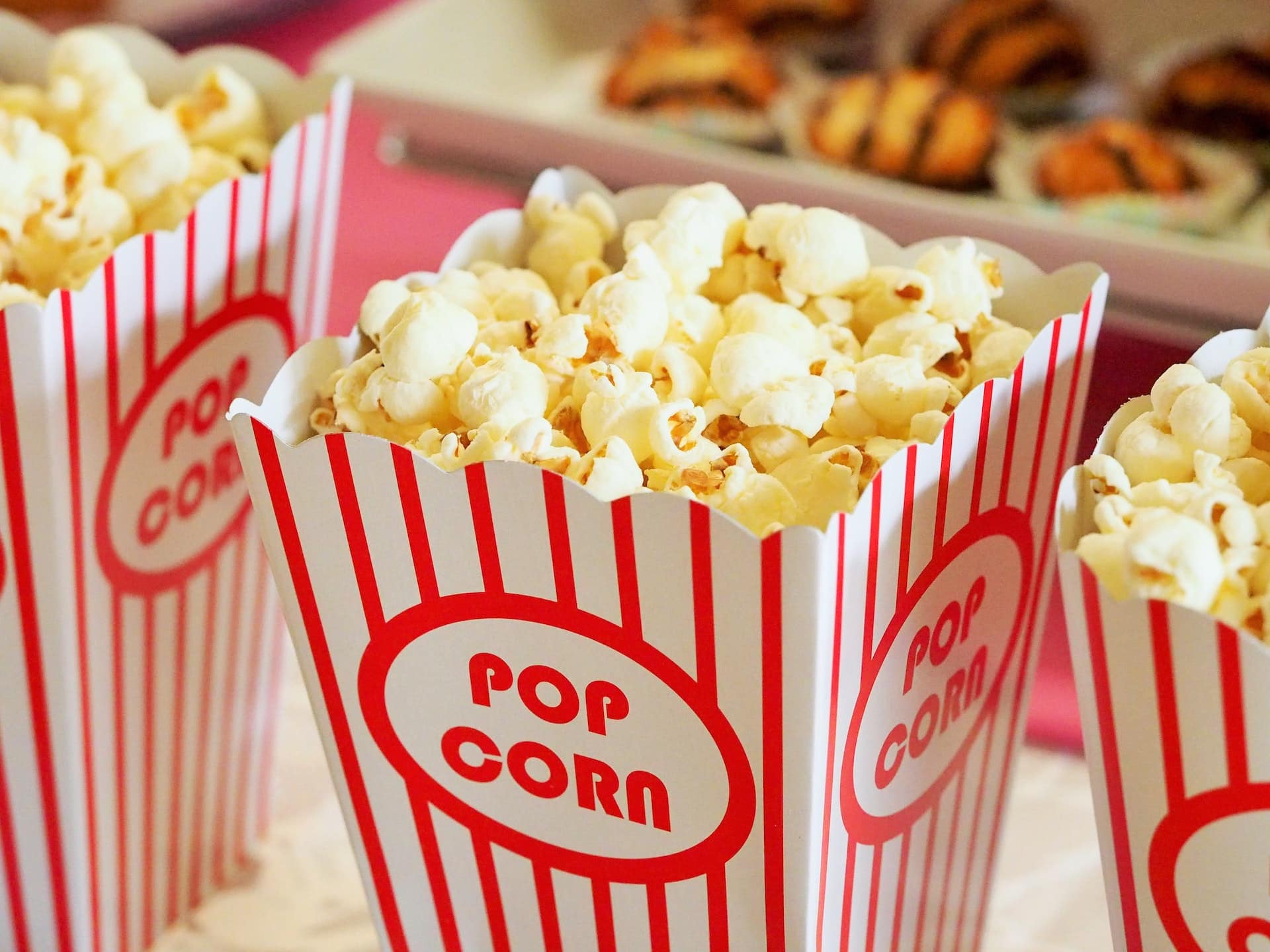 horizontal photo of three red and white striped boxes of popcorn. Image from Pexels https://www.pexels.com/photo/food-snack-popcorn-movie-theater-33129/