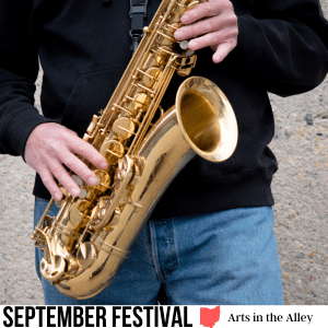 square image with a photo of a man playing a saxophone. A white strip at the bottom has the text September Festival Arts in the Alley. Image via Canva pro license