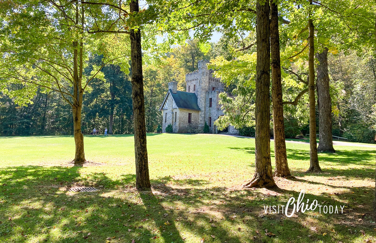 horizontal photo of the approach to Squire's Castle, with the castle in the background, through the trees. Photo credit: Cindy Gordon of VisitOhioToday.com