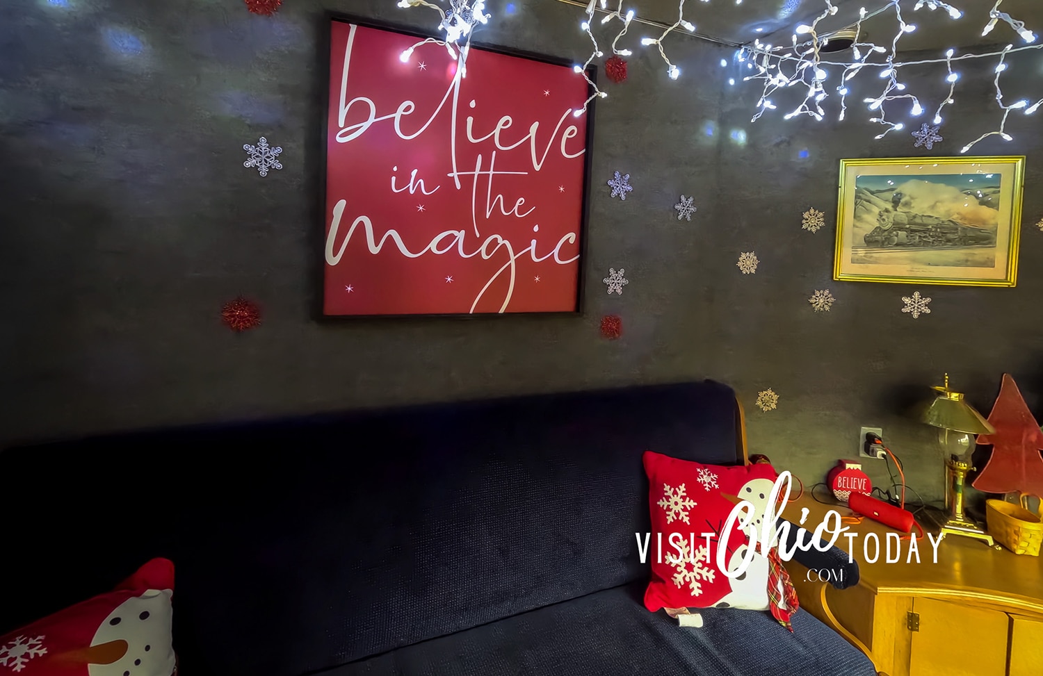 horizontal image of the inside of the Polar Express Train of the Dennison Railroad with an image on the wall with the text 'believe in the magic'. Photo credit: Cindy Gordon of VisitOhioToday.com