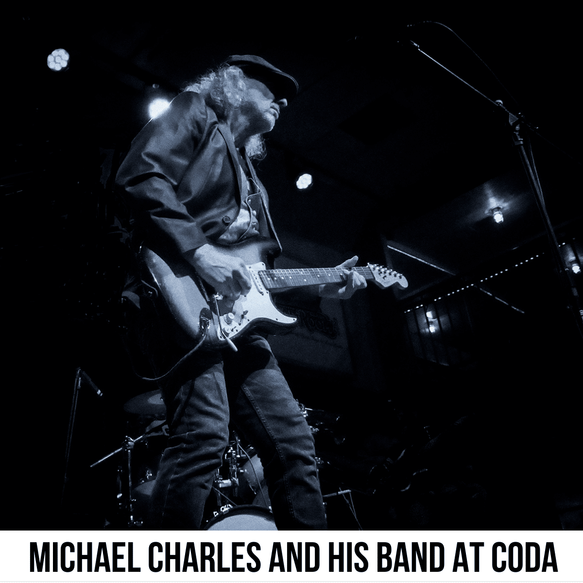 square image with a black and white photo of Michael Charles playing his guitar on stage. A white strip across the bottom has the text Michael Charles and His Band at CODA