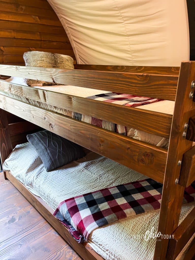 photos from inside the lux covered wagon at garystone ranch, showing wooden bunk beds photo credit: Cindy Gordon of VisitOhioToday.com