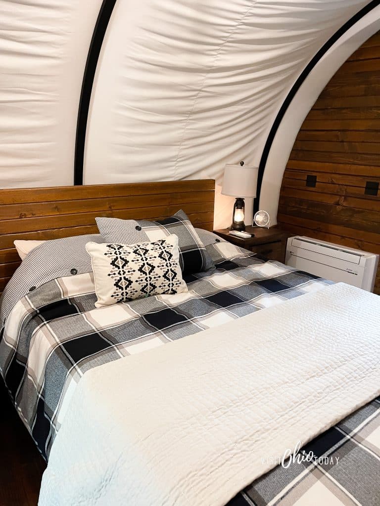 photos from inside the lux covered wagon at garystone ranch, showing a double bed photo credit: Cindy Gordon of VisitOhioToday.com