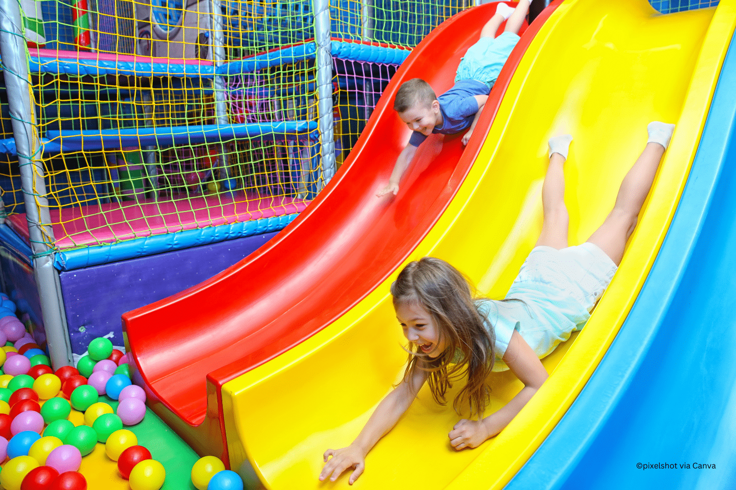 horizontal photo of some colorful slides into a ball pit