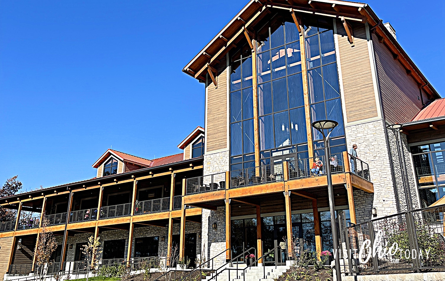 horizontal image of the front of Hocking Hills Lodge with a very blue sky in the background. Photo credit: Cindy Gordon of VisitOhioToday.com