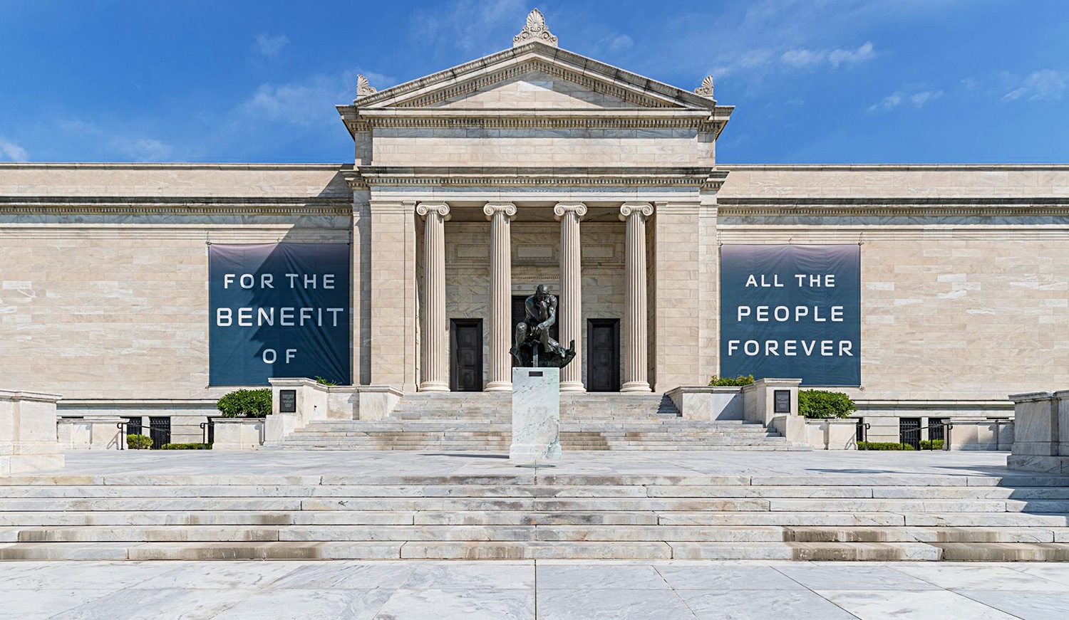 horizontal photo of the Cleveland Museum of Art with banners on the walls with the text For the Benefit of all the people forever