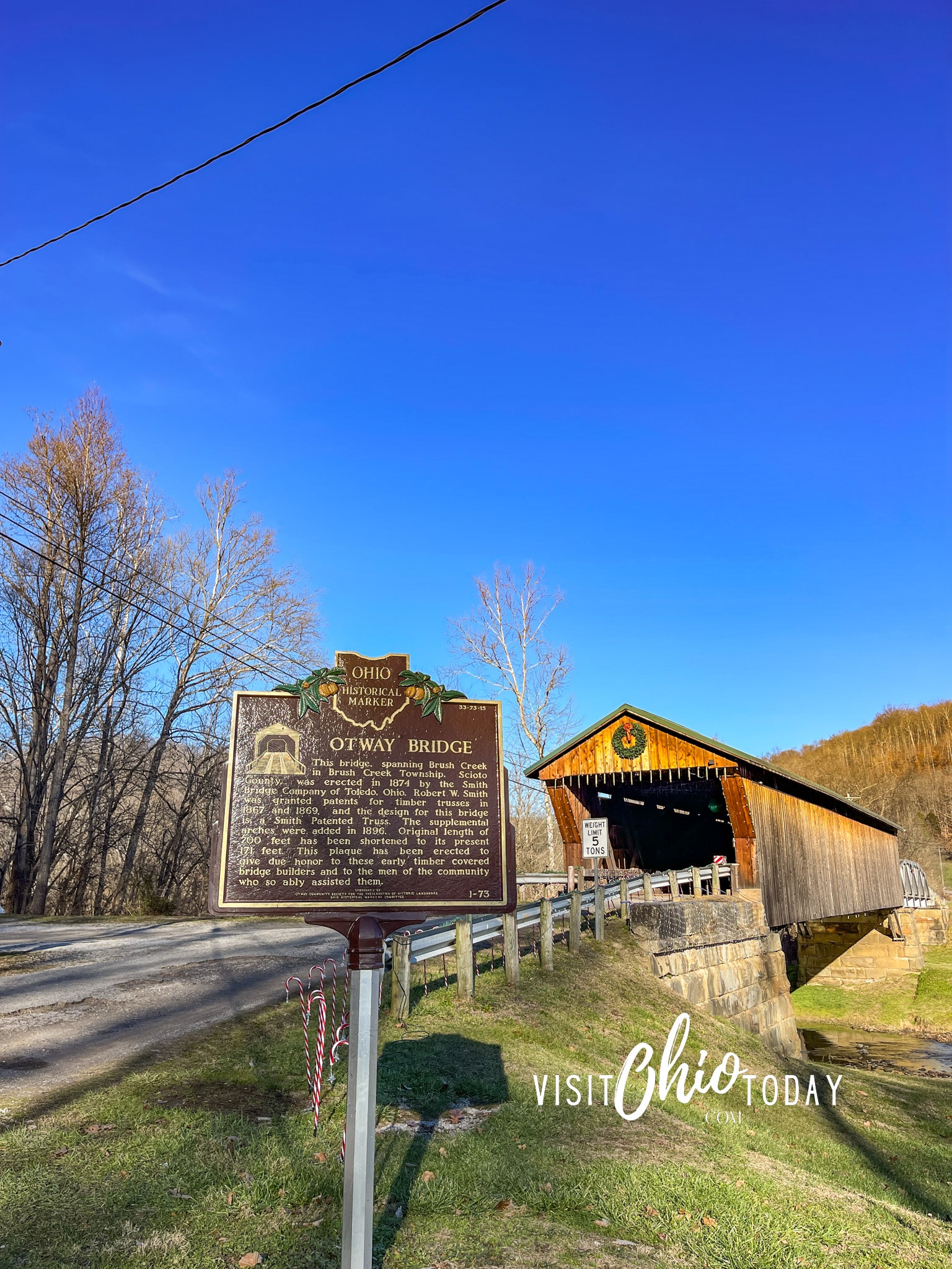 vertical photo of the Otway Bridge with the historic marker in the foreground. Photo credit: Cindy Gordon of VisitOhioToday.com