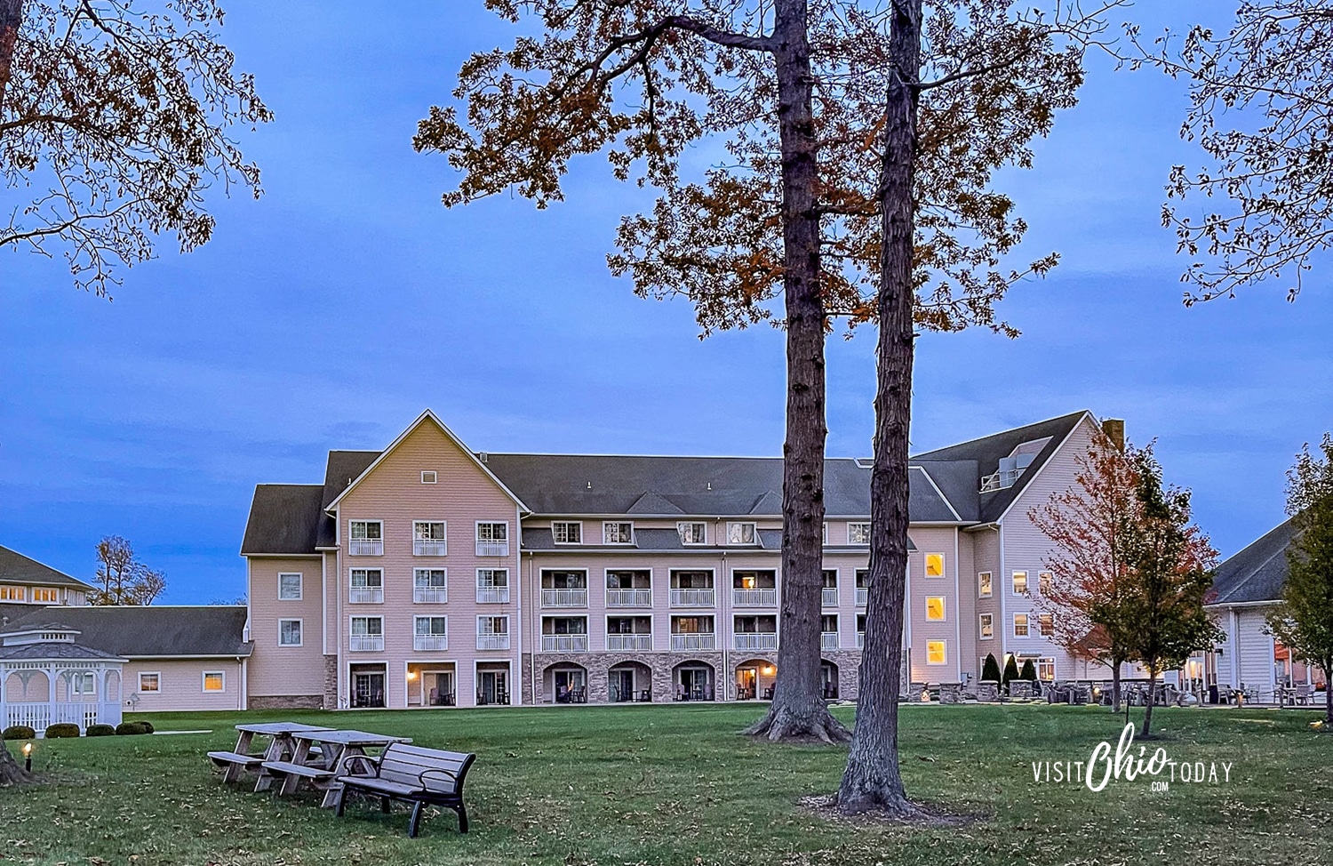 horizontal photo of the Lodge at Geneva-on-the-Lake with a grassy area and trees in the foreground. Photo credit: Cindy Gordon of VisitOhioToday.com