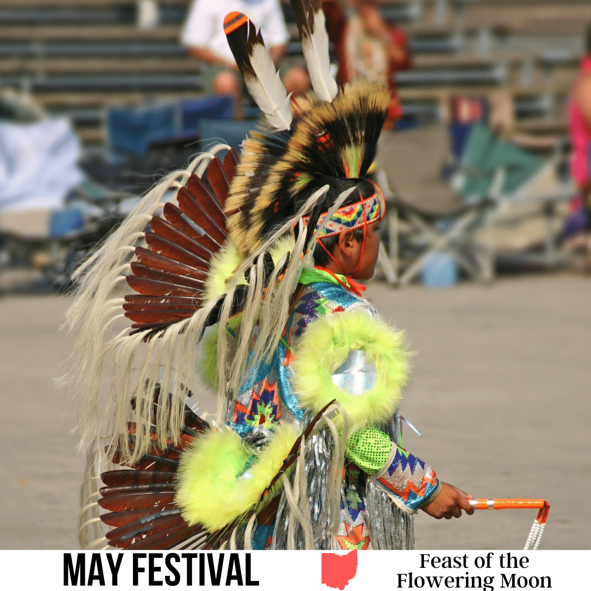 A square image of a person in Native American ceremonial attire, with a crowd watching from the stands in the background. A white strip across the bottom has text May Festival Feast of the Flowering Moon.