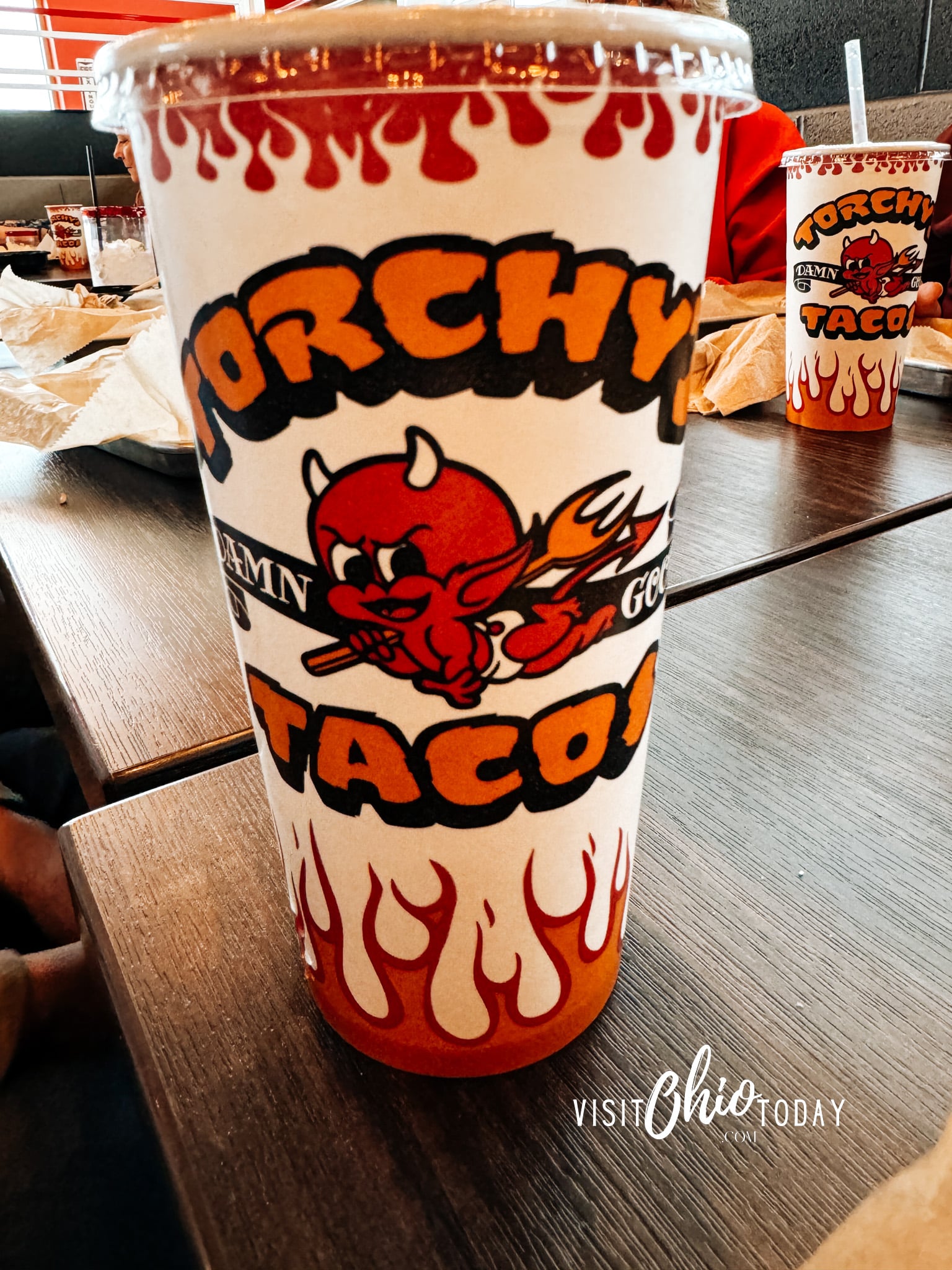 vertical photo of a Torchy's Tacos drinking cup on a table. Photo credit: Cindy Gordon of VisitOhioToday.com
