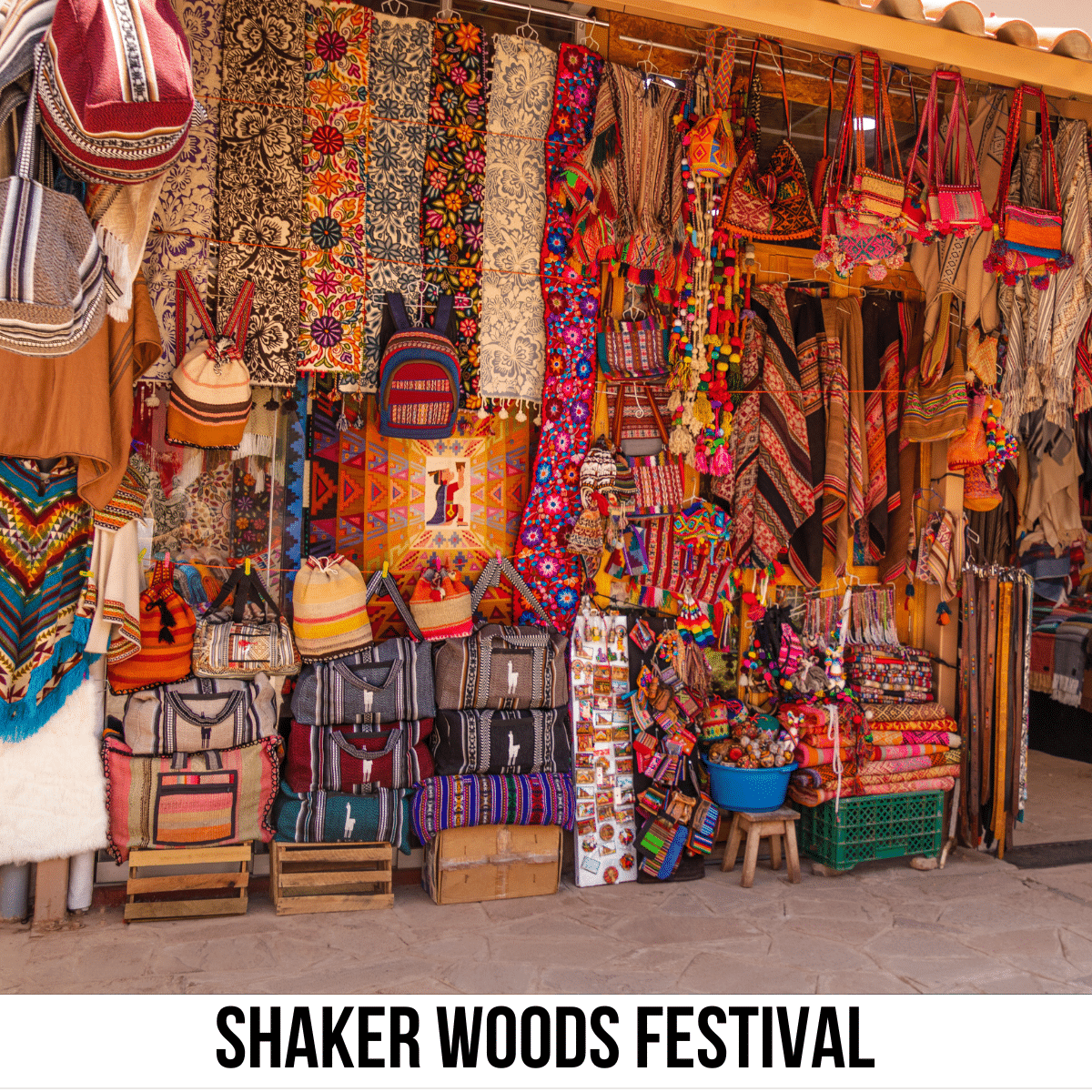 A square image of a photo of a wall in an outdoor market, filled with colorful bags and scarves. A white strip across the bottom has text Shaker Woods Festival.