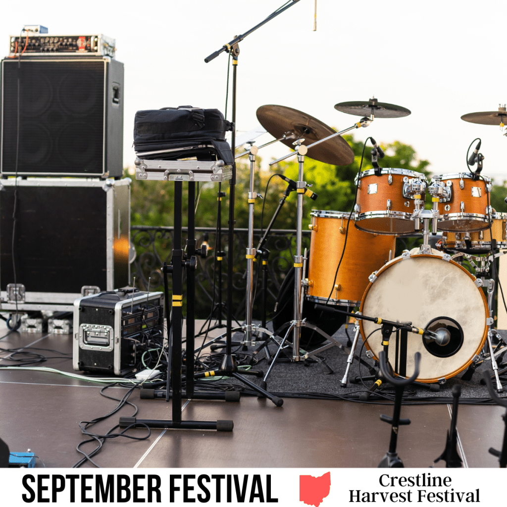 square image with a photo of a stage ready for a band to play. A white strip across the bottom has the text September Festival Crestline Harvest Festival