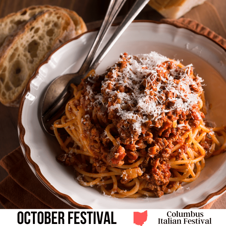 square image with an overhead photo of a bowl of spaghetti bolognese with a spoon and fork in the bowl and some bread behind the bowl. A white strip across the bottom contains the text October Festival. Columbus Italian Festival