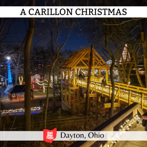 square image with a photo of a lit covered bridge, with light-adorned buildings in the background. A white strip across the top has the text A Carillon Christmas, and a white strip across the bottom has the text Dayton, Ohio