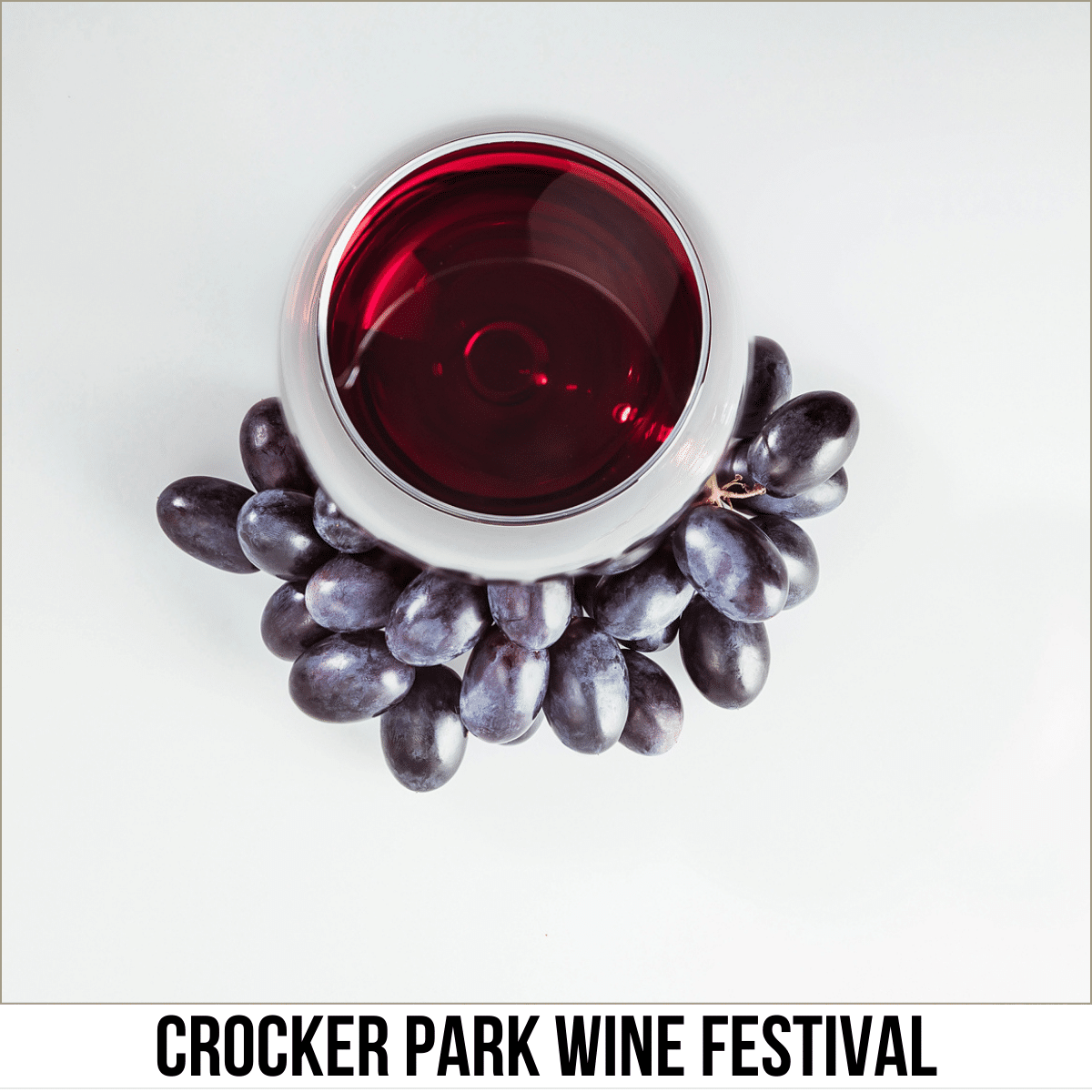 A square image of a photo of a downward shot of a glass of wine, surrounded by grapes, against a light-colored background. A white strip across the bottom has text Crocker Park Wine Festival.