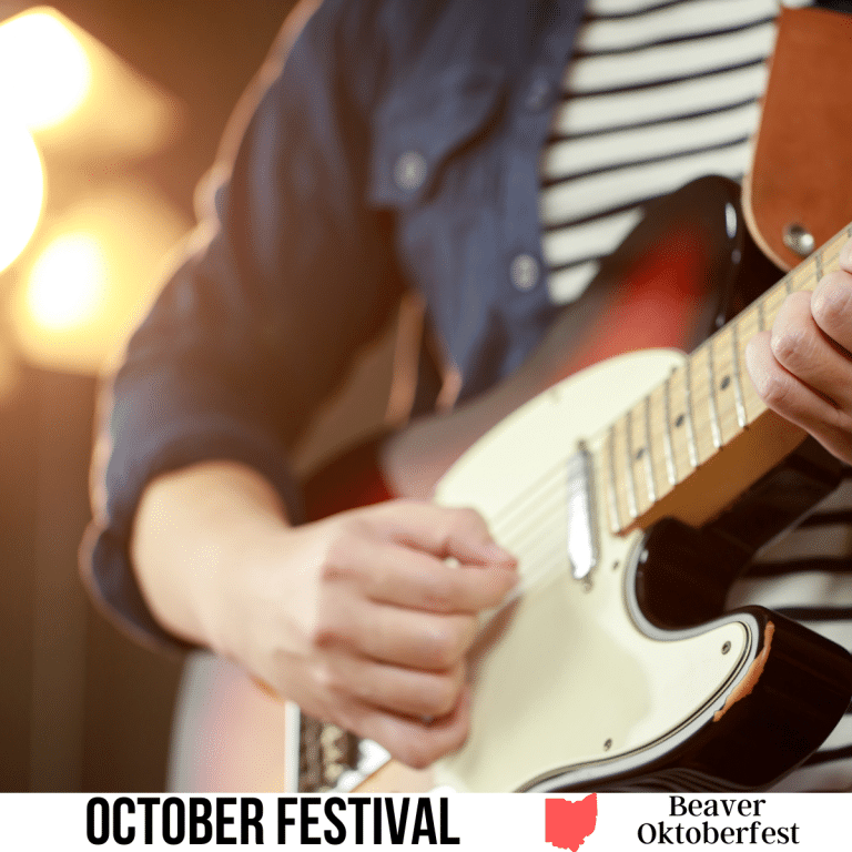 A square image of a close up photo of a person in a black and white striped shirt and button up shirt/jacket playing the guitar. A white strip across the bottom has text October Festival Beaver Oktoberfest