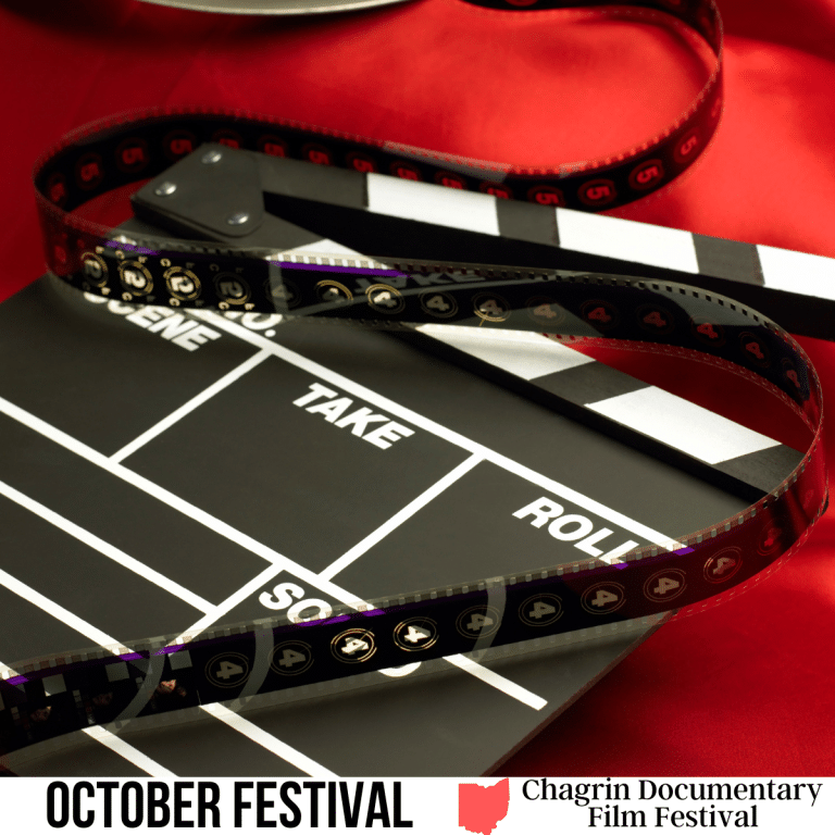 A square image of a photo of a clapboard from a movie set, lying on red fabric, with a roll of film unrolled across it. A white strip across the bottom has text October Festival Chagrin Documentary Film Festival.