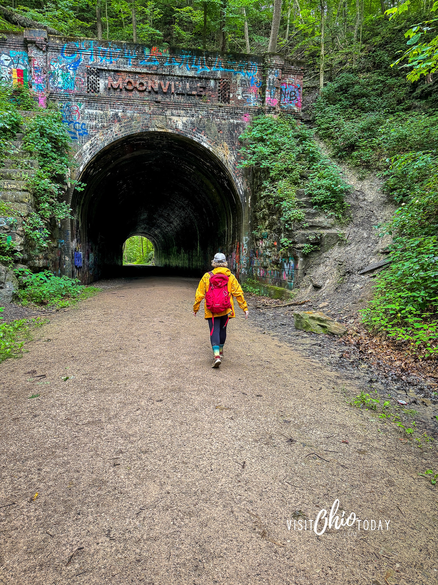 vertical photo of Cindy Gordon walking toward Moonville Tunnel. Photo credit: Cindy Gordon of VisitOhioToday.com