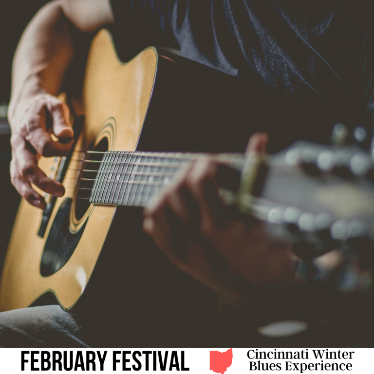 A square image of a photo of an acoustic guitar sitting on someone's lap, while they are strumming it. A white strip across the bottom has text February Festival Cincinnati Winter Blues Experience.