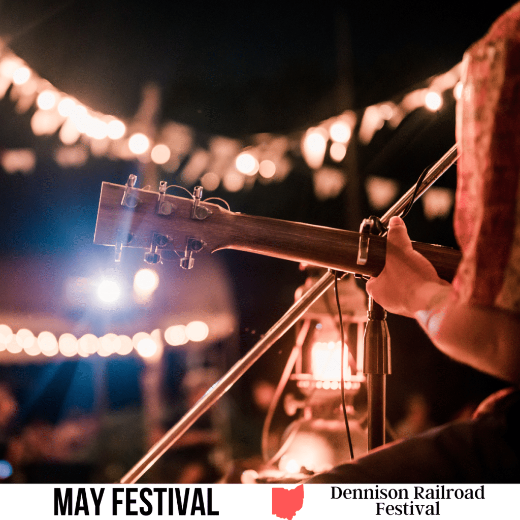 square image with a photo of a guitar player on stage. A white strip across the bottom has the text May Festival. Dennison Railroad Festival