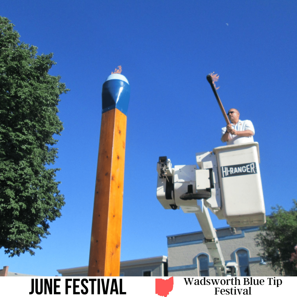 square image with a photo of a man lighting the giant blue tipped match. A white strip across the bottom has the text June Festival. Wadsworth Blue Tip Festival