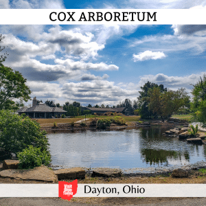 square image with a photo of the lake at the arboretum. A white strip across the top has the text Cox Arboretum, and a white strip across the bottom has the text Dayton, Ohio