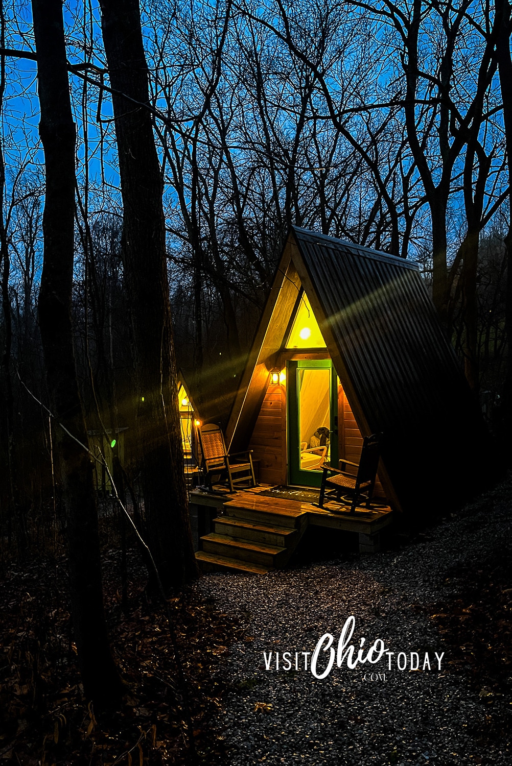 vertical photo of the Green Getaway A-frame rental cabin at nighttime. Photo credit: Cindy Gordon of VisitOhioToday.com