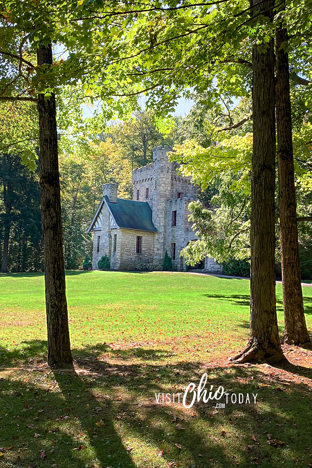 vertical photo of Squire's Castle through the trees. Photo credit: Cindy Gordon of VisitOhioToday.com