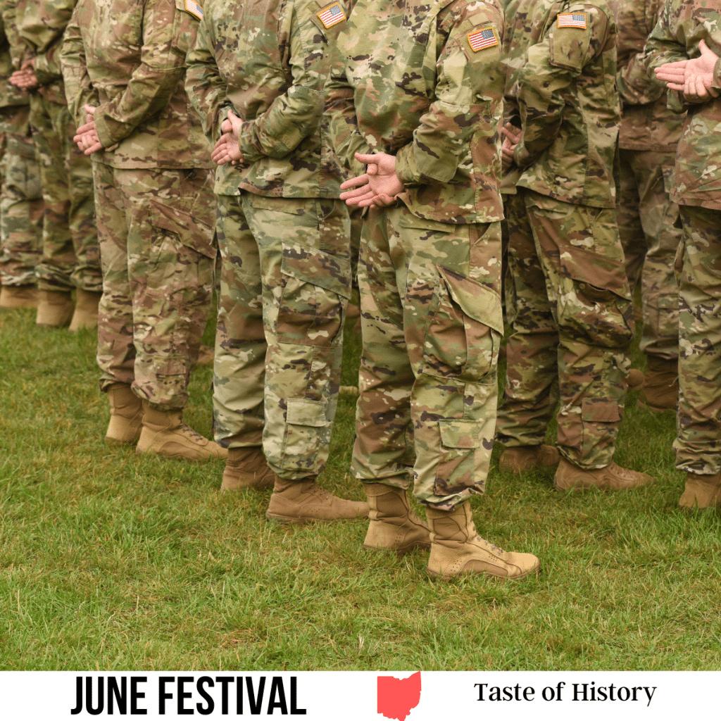 square image with a photo of the legs of as US Army platoon. A white strip across the bottom has the text June Festival. Taste of History