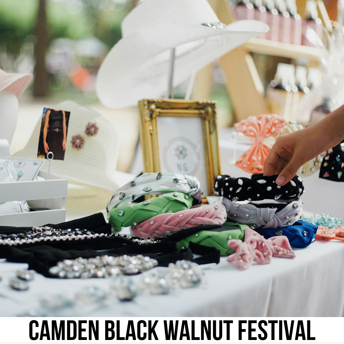 square image with a photo of a booth at a craft fair. A white strip at the bottom has the text Camden Black Walnut Festival