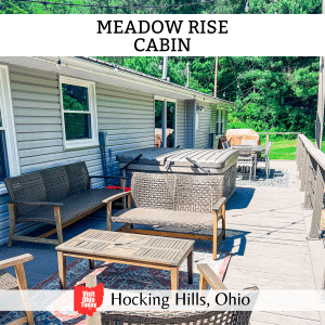 square image with a photo of the outside seating area and hot tub at the cabin. A white strip across the top has the text Meadow Rise Cabin, and a white strip across the bottom has the text Hocking Hills, Ohio