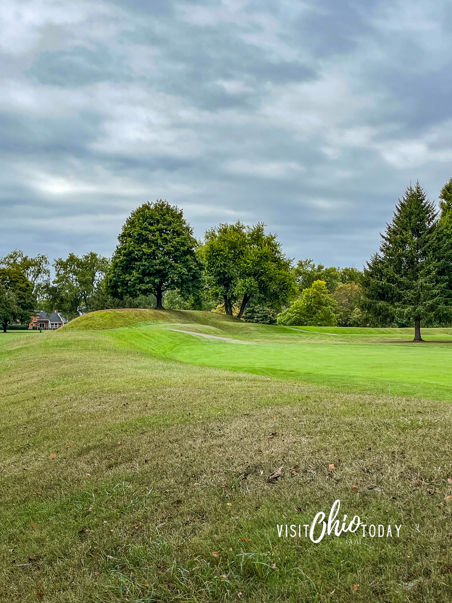 vertical photo of one of the mounds at Octagon Earthworks with trees in the background. Photo credit: Cindy Gordon of VisitOhioToday.com