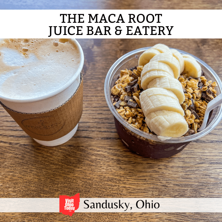square image with a drink and bowl of food on a wooden table top. A white strip across the top has the text The Maca Root Juice Bar & Eatery, and a white strip across the bottom has the text Sandusky, Ohio